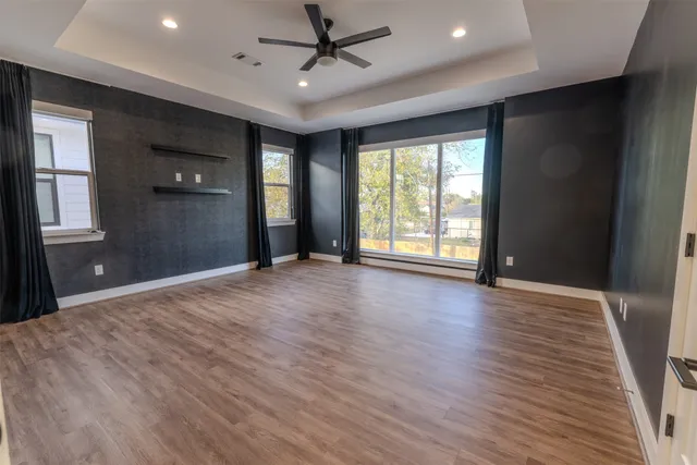 a view of an empty room with glass door and a window