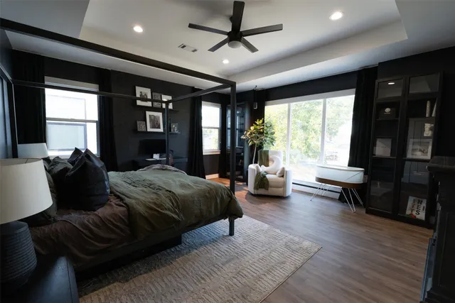 a spacious bedroom with a bed couch and a large window