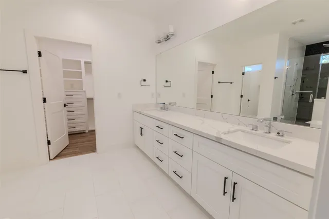a bathroom with a double vanity sink mirror and double