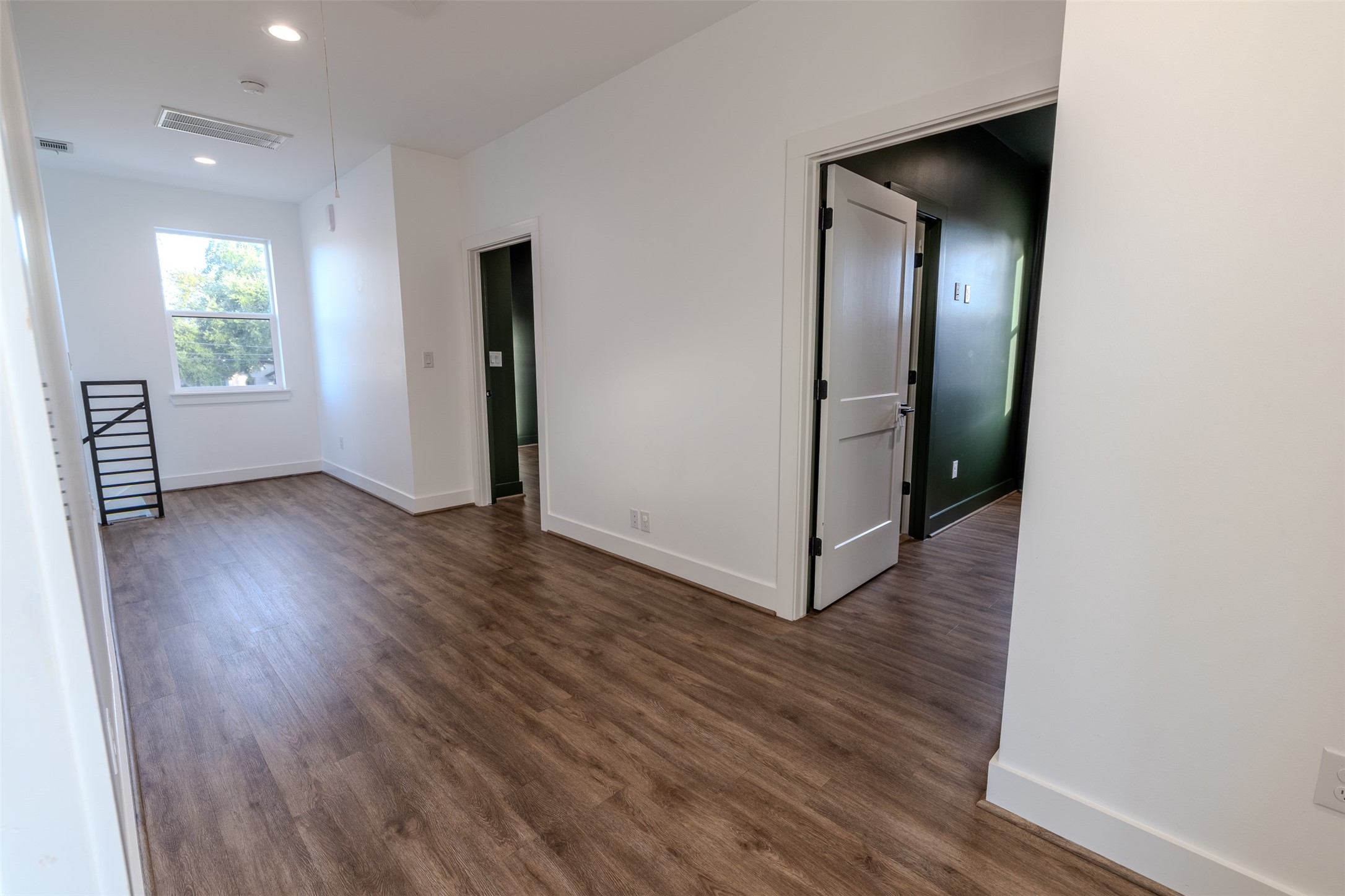 1206 Hamblen Street Houston, TX 77009 - Photo 18 of 28 an empty room with wooden floor and windows