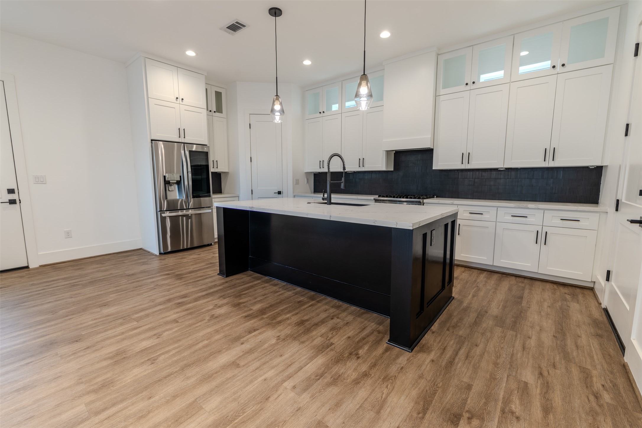 1206 Hamblen Street Houston, TX 77009 - Photo 3 of 28 a kitchen with stainless steel appliances granite countertop a sink a stove and a refrigerator