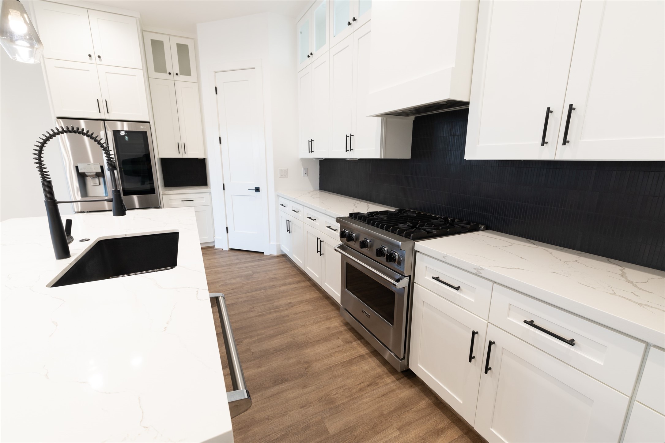 1206 Hamblen Street Houston, TX 77009 - Photo 6 of 28 a kitchen with granite countertop a stove a sink and a microwave