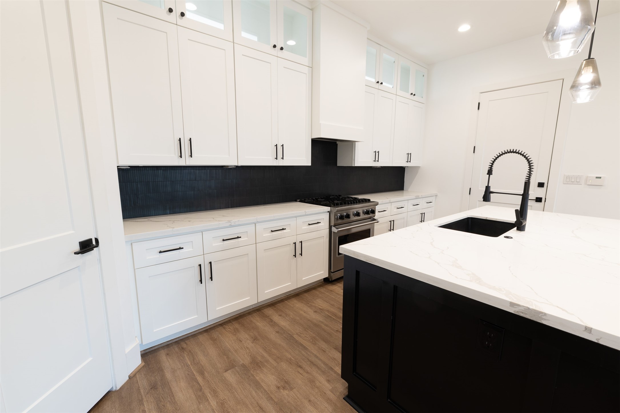 1206 Hamblen Street Houston, TX 77009 - Photo 7 of 28 a kitchen with a sink a stove and cabinets