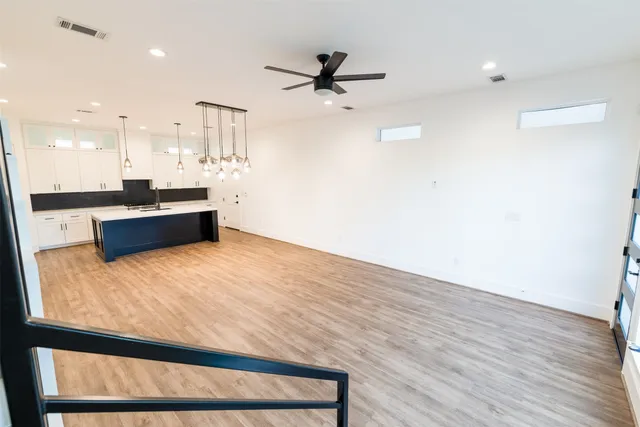 a large white kitchen with a large window