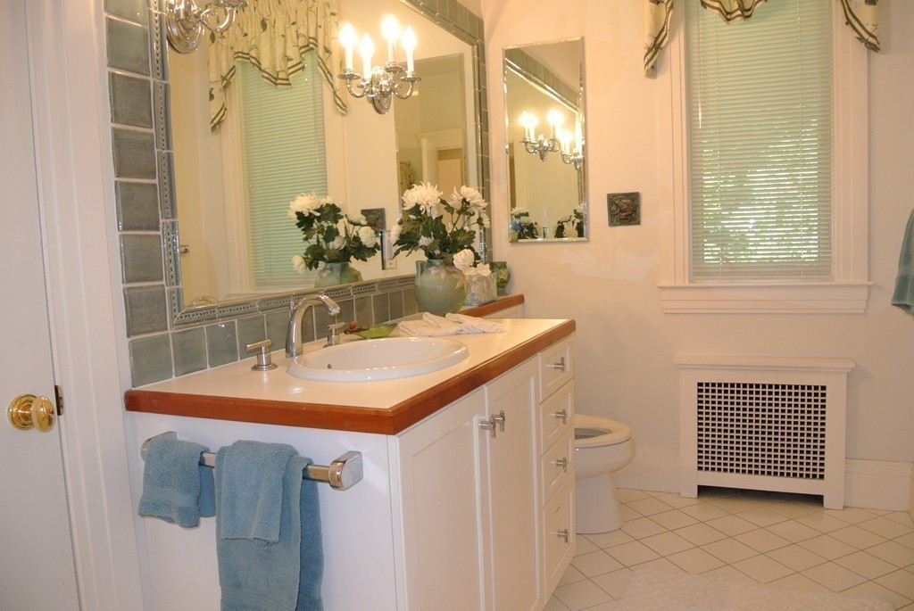423 Concord Road Weston, MA 02493 - Photo 22 of 30 a bathroom with a sink a mirror and a shower