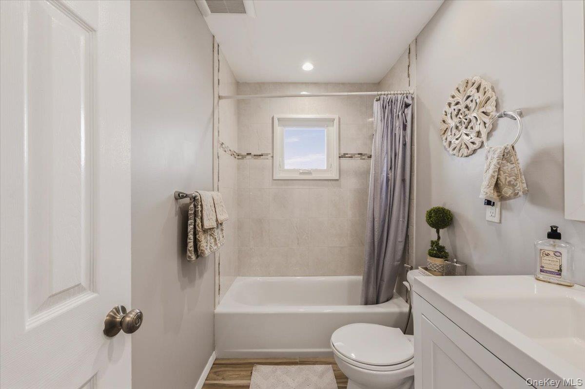 3309 Nelson Street Wantagh, NY 11793 - Photo 24 of 39 a bathroom with a sink toilet and shower