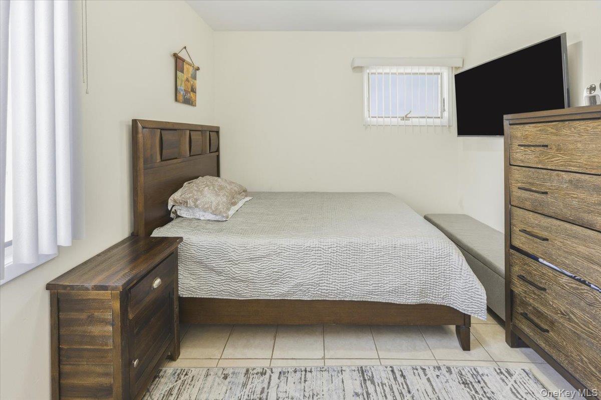 3309 Nelson Street Wantagh, NY 11793 - Photo 25 of 39 a bedroom with a bed and flat screen tv