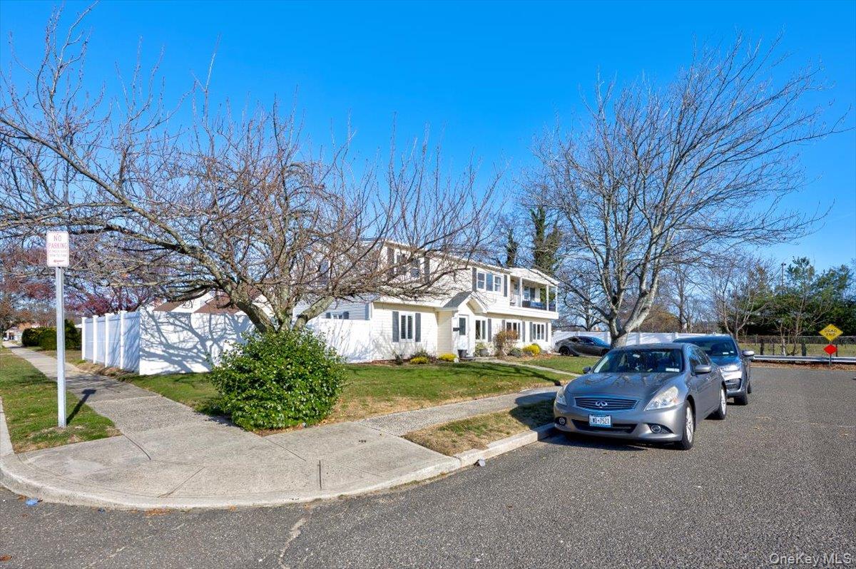 3309 Nelson Street Wantagh, NY 11793 - Photo 36 of 39 a front view of a house with a yard and garage
