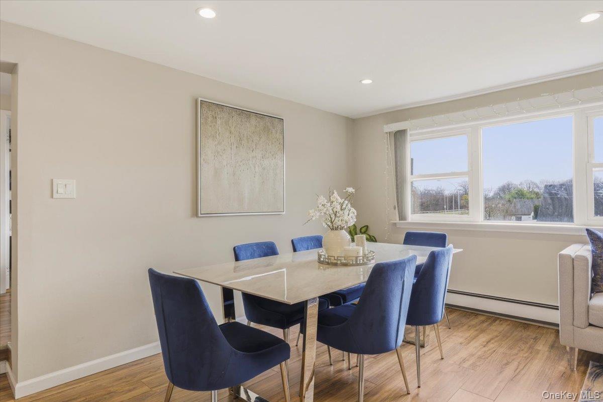 3309 Nelson Street Wantagh, NY 11793 - Photo 8 of 39 a view of a dining room with furniture window and wooden floor