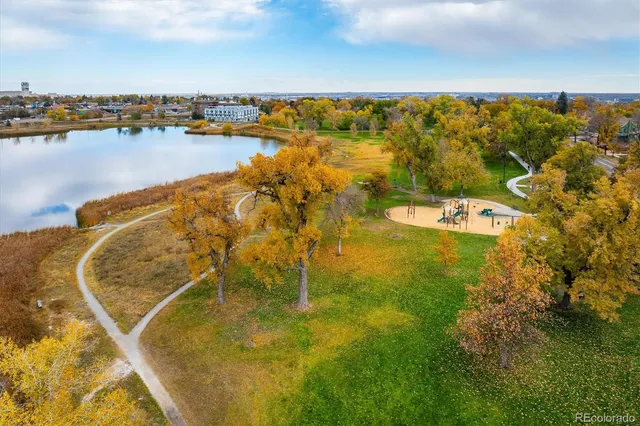 an aerial view of residential houses with outdoor space and lake view