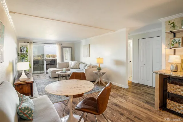 a living room with furniture a fireplace and a table