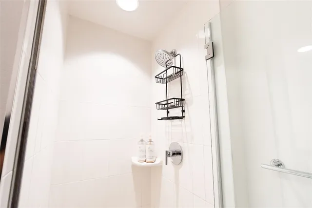 a bedroom with a bed and a night stand