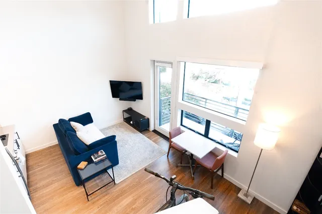 a living room with chairs and a window
