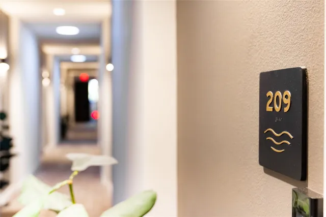 a view of a hallway with wooden floor and a glass door