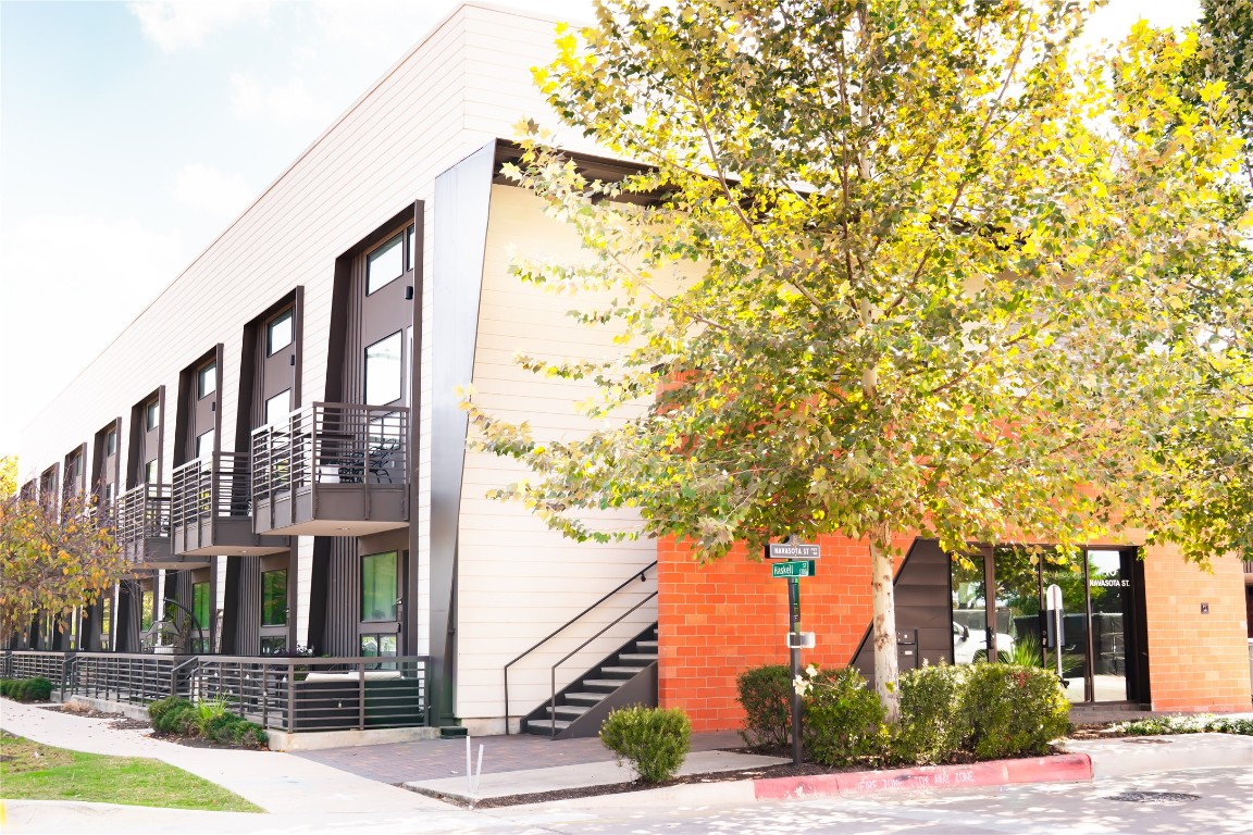 49 Navasota Street, Unit 209 Austin, TX 78702 - Photo 26 of 32 front view of a building with a tree