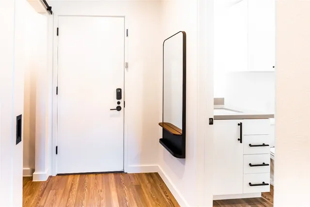 a view of a room with wooden floor
