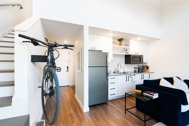 a kitchen with a refrigerator and a sink