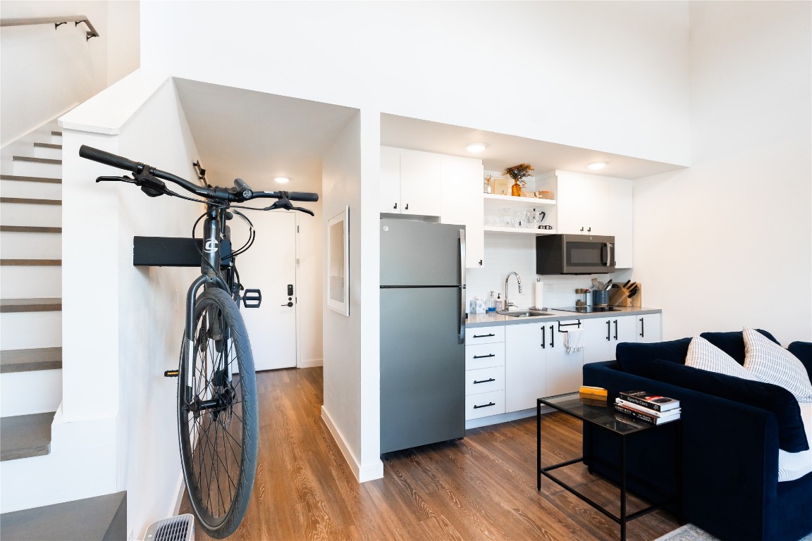 49 Navasota Street, Unit 209 Austin, TX 78702 - Photo 6 of 32 a kitchen with a refrigerator and a sink