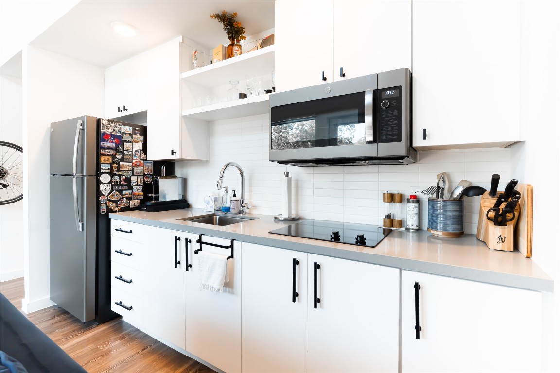 49 Navasota Street, Unit 209 Austin, TX 78702 - Photo 8 of 32 a kitchen with stainless steel appliances a sink a stove and a refrigerator