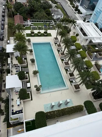 a view of a dining room with furniture and garden view