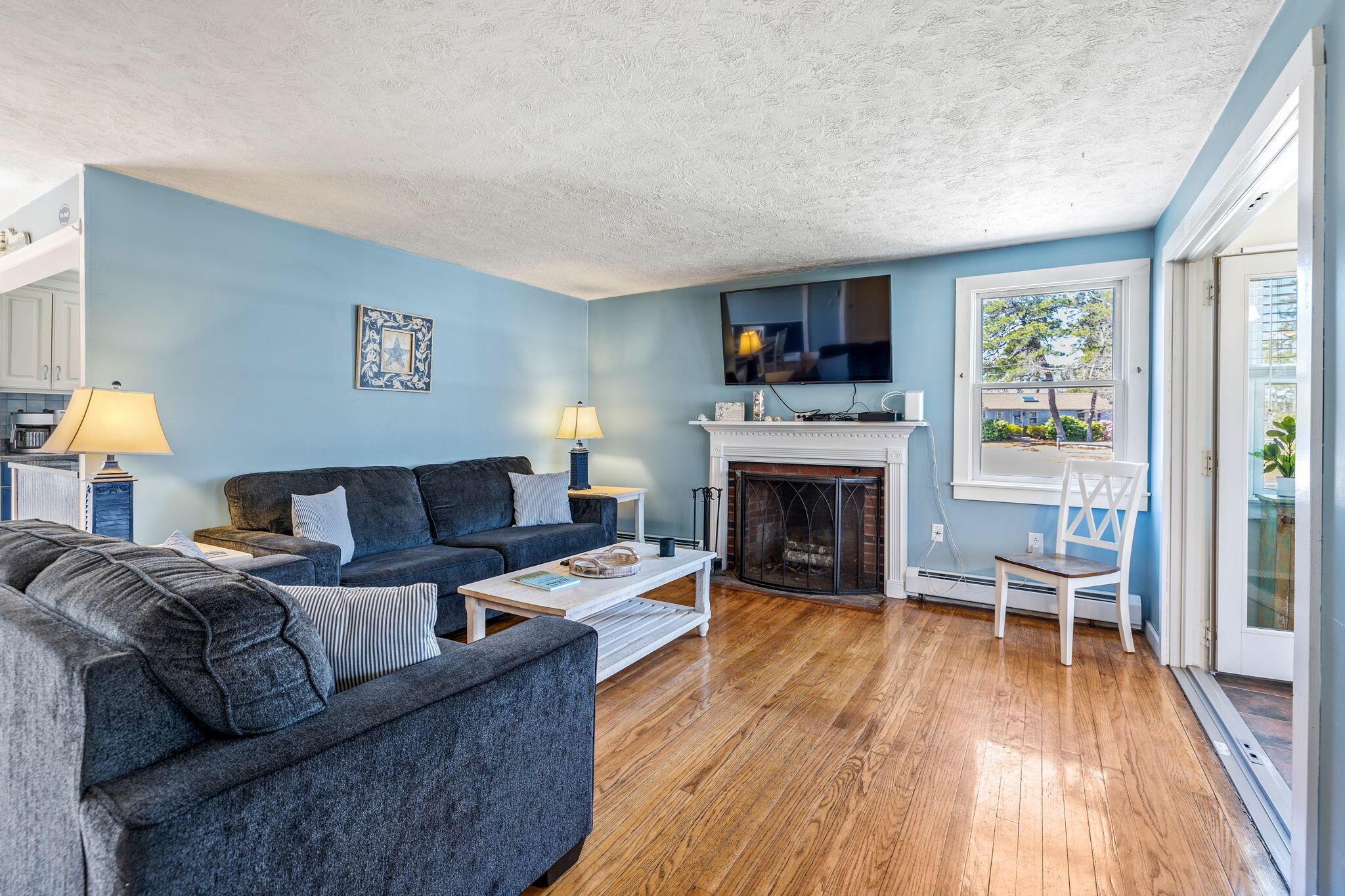 121 Lower County Road Dennis Port, MA 02639 - Photo 19 of 37 a living room with furniture and a fireplace