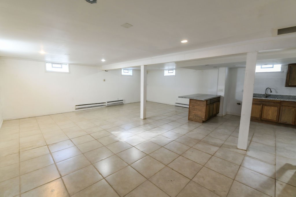 281 Ellison Street Rochester, NY 14609 - Photo 18 of 26 A large basement finished area, has glass block wi