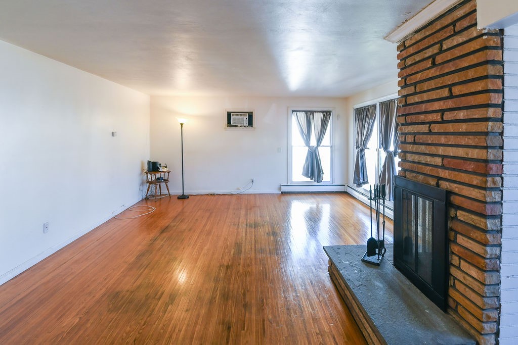 281 Ellison Street Rochester, NY 14609 - Photo 3 of 26 Living room with fireplace, hardwood floors and lo