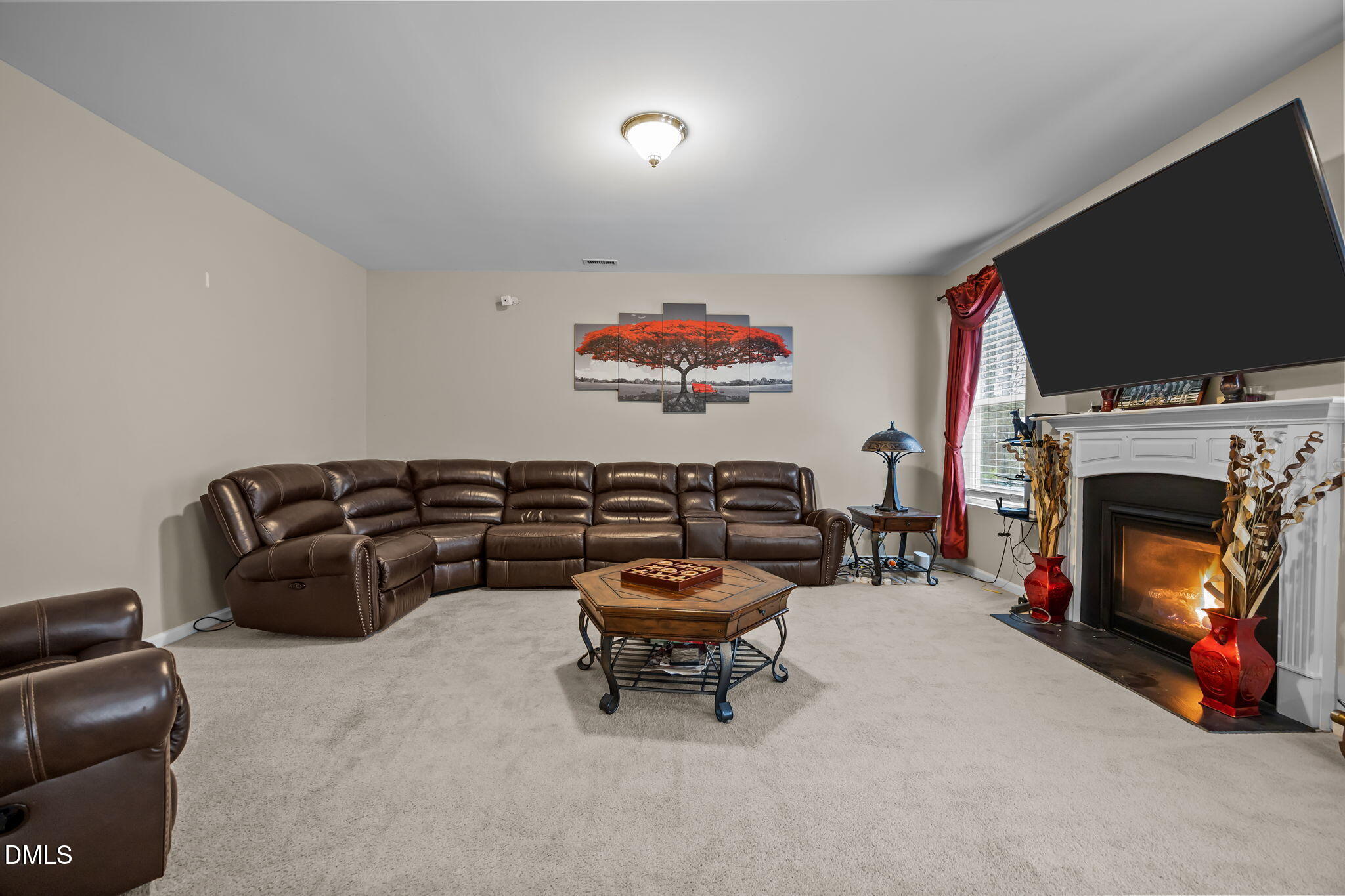 2021 Muddy Creek Court Raleigh, NC 27610 - Photo 8 of 47 a living room with furniture a flat screen tv and a fireplace
