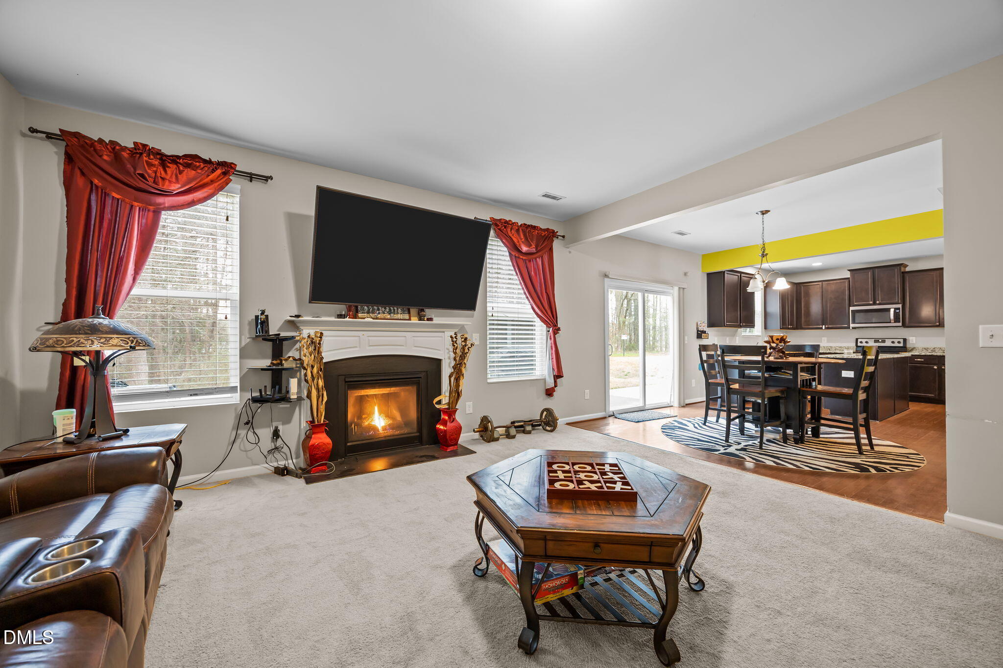 2021 Muddy Creek Court Raleigh, NC 27610 - Photo 9 of 47 a living room with furniture a flat screen tv and a fireplace