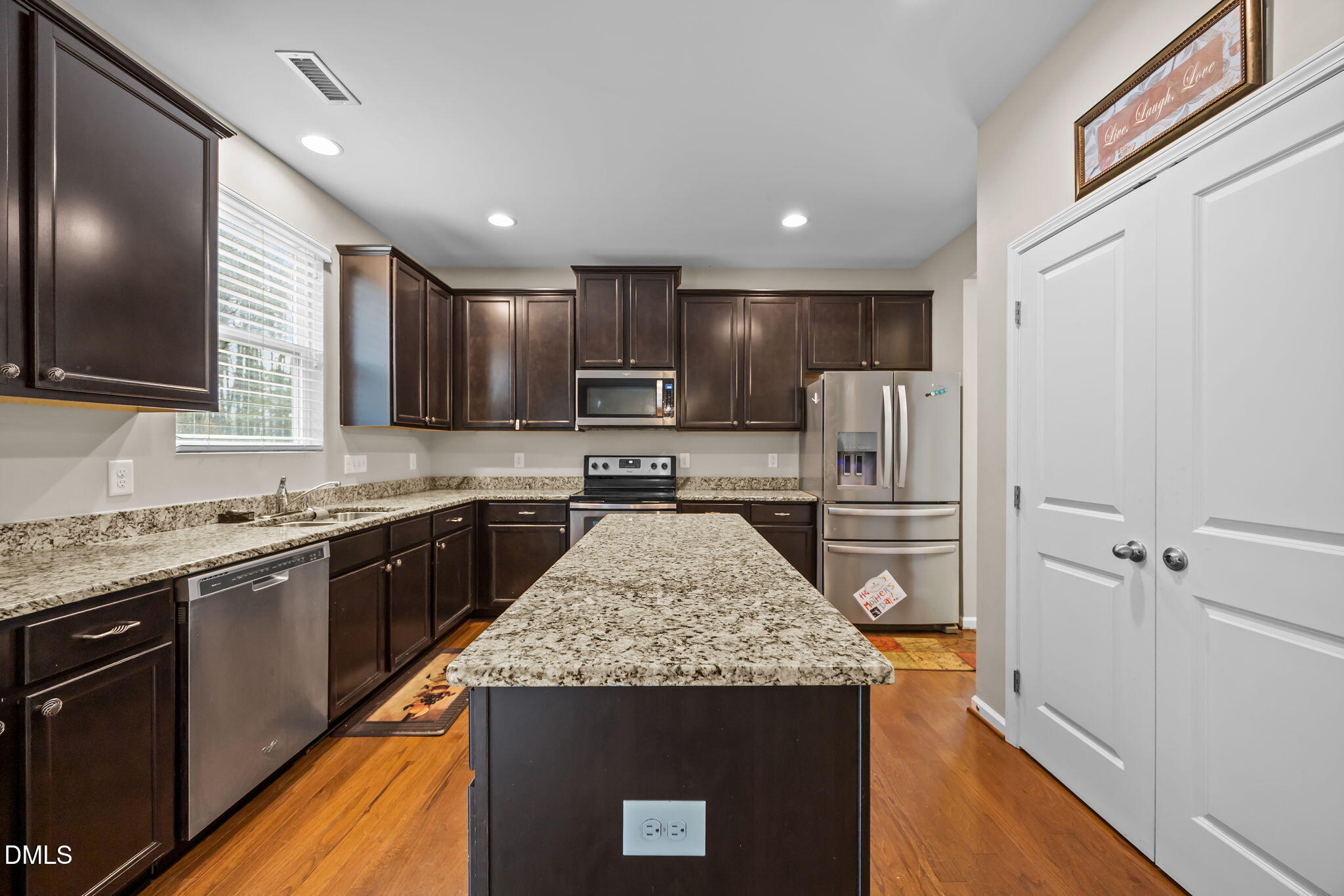 2021 Muddy Creek Court Raleigh, NC 27610 - Photo 12 of 47 a kitchen with kitchen island granite countertop stainless steel appliances sink stove microwave and cabinets