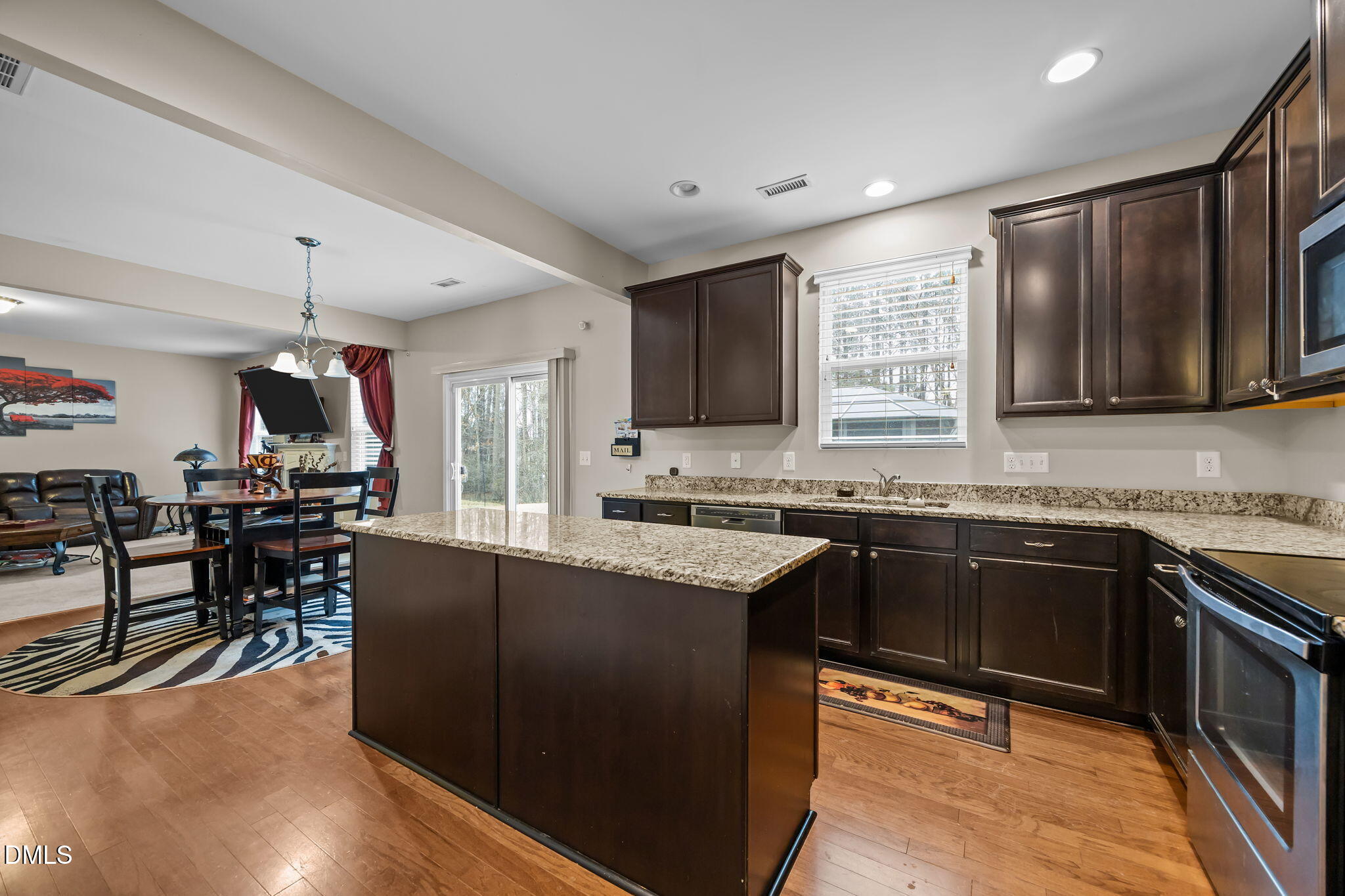 2021 Muddy Creek Court Raleigh, NC 27610 - Photo 14 of 47 a kitchen with stainless steel appliances granite countertop sink stove top oven and cabinets