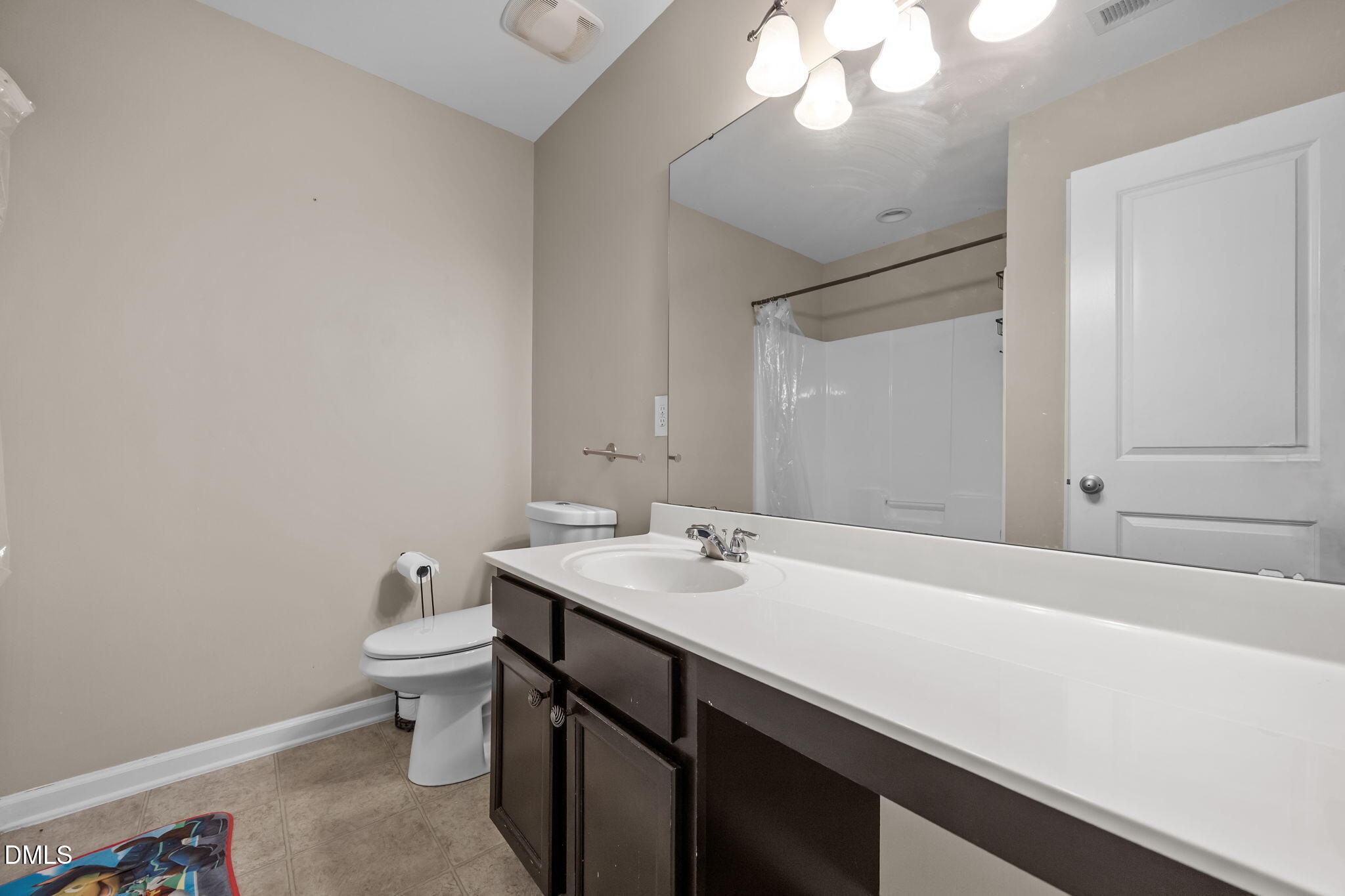 2021 Muddy Creek Court Raleigh, NC 27610 - Photo 24 of 47 a bathroom with a sink a toilet and a mirror