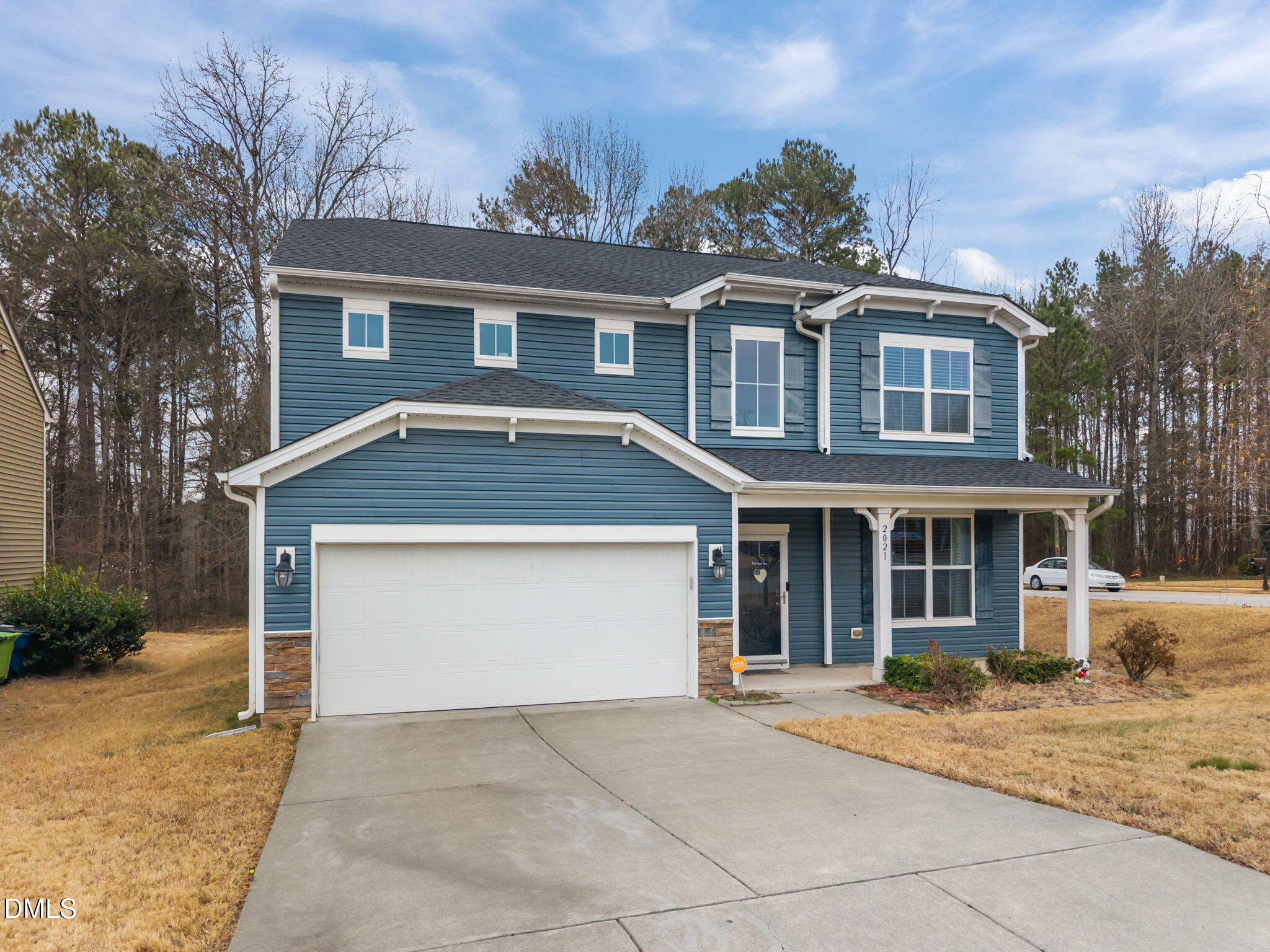 2021 Muddy Creek Court Raleigh, NC 27610 - Photo 4 of 47 a front view of a house with a yard and garage