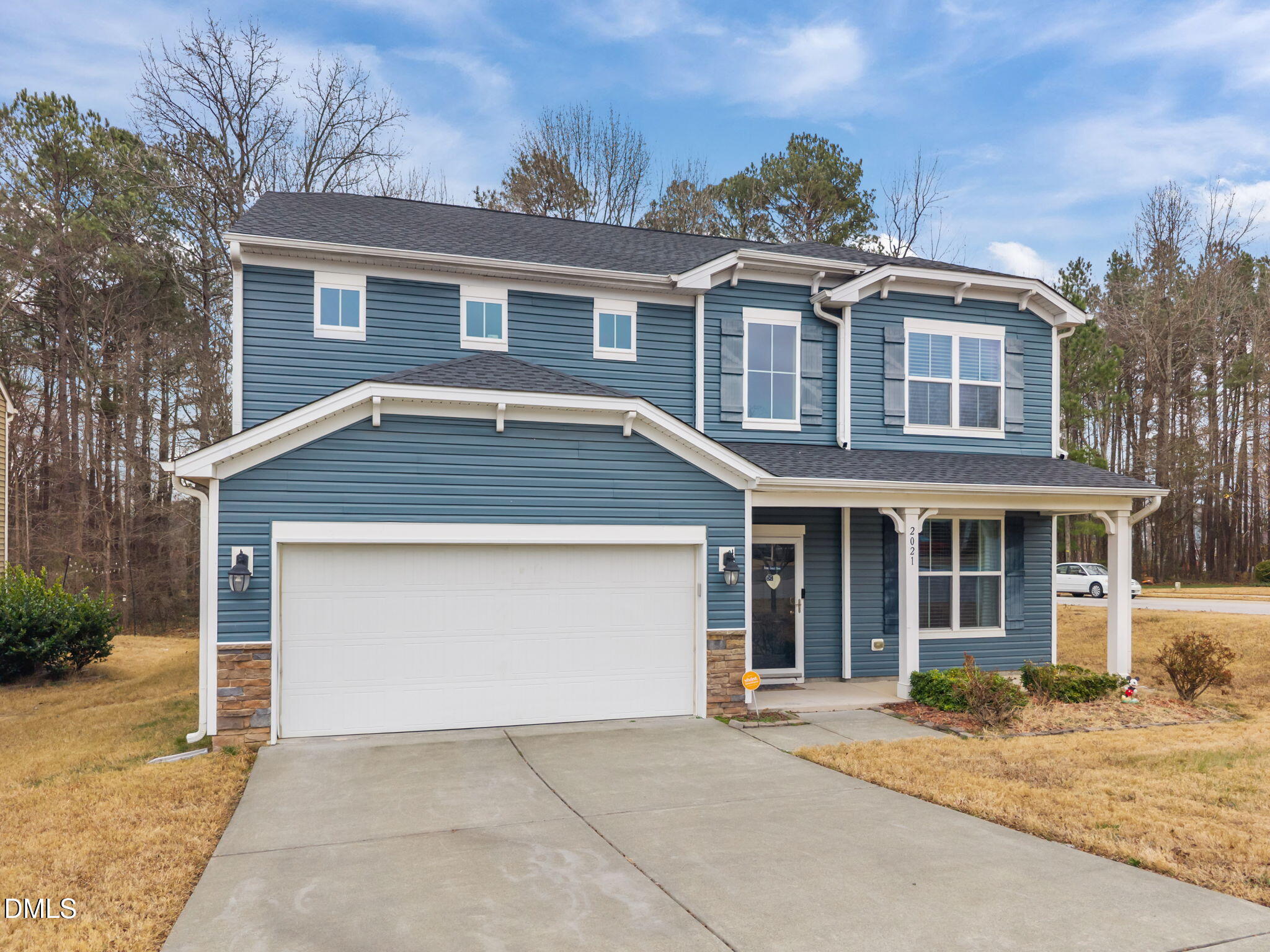 2021 Muddy Creek Court Raleigh, NC 27610 - Photo 5 of 47 a front view of a house with a yard and garage