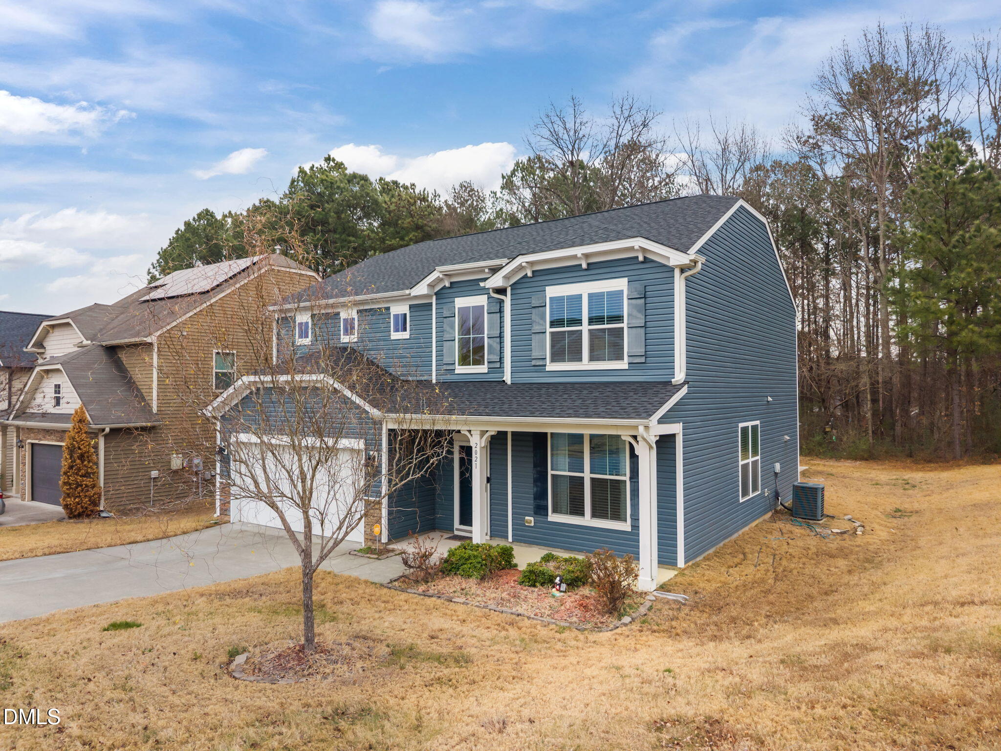 2021 Muddy Creek Court Raleigh, NC 27610 - Photo 6 of 47 a front view of a house with a yard and garage