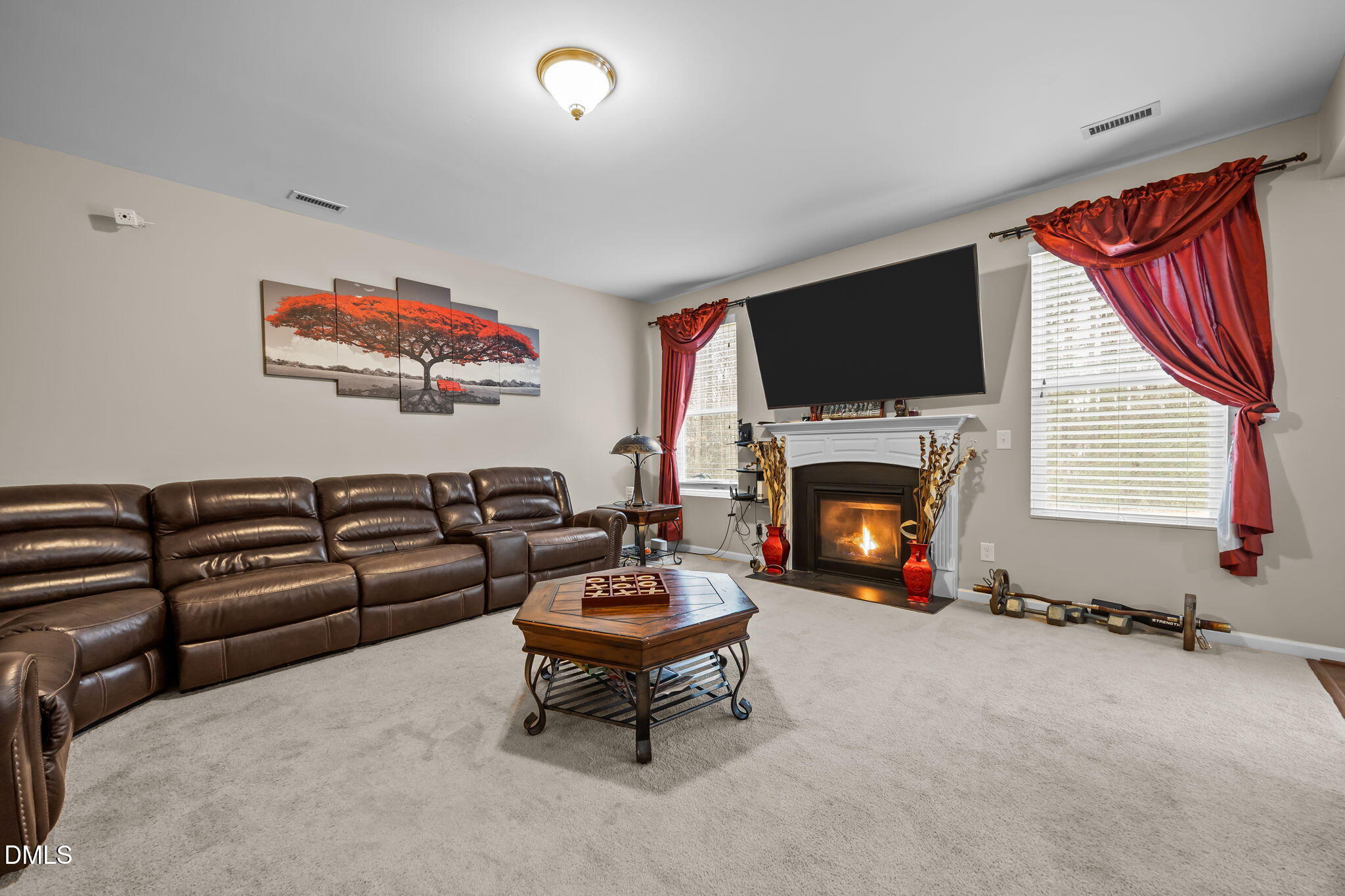 2021 Muddy Creek Court Raleigh, NC 27610 - Photo 7 of 47 a living room with furniture a fireplace and a flat screen tv