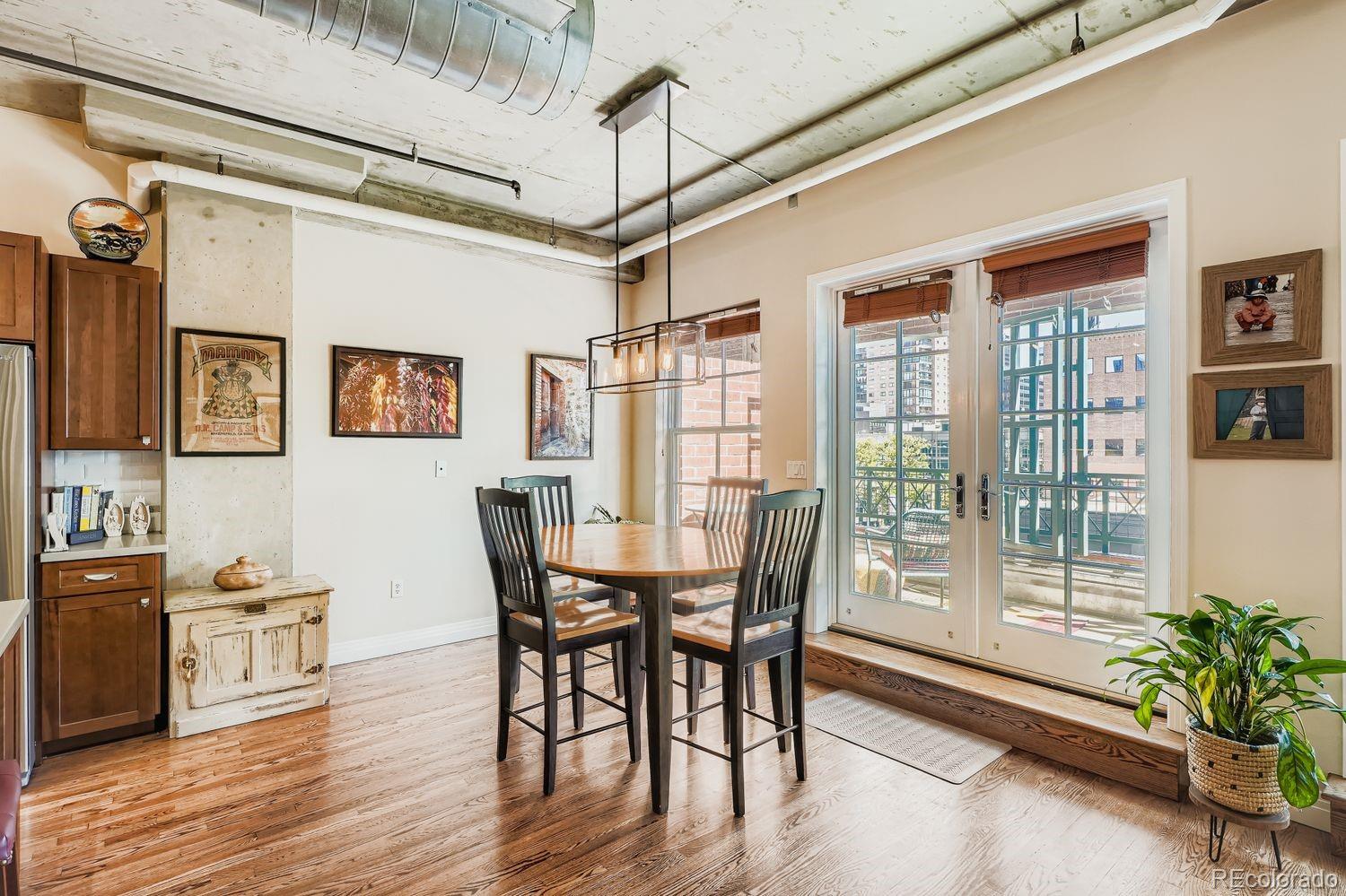 1499 Blake Street, Unit 4G Denver, CO 80202 - Photo 11 of 33 a view of a dining room with furniture window and wooden floor