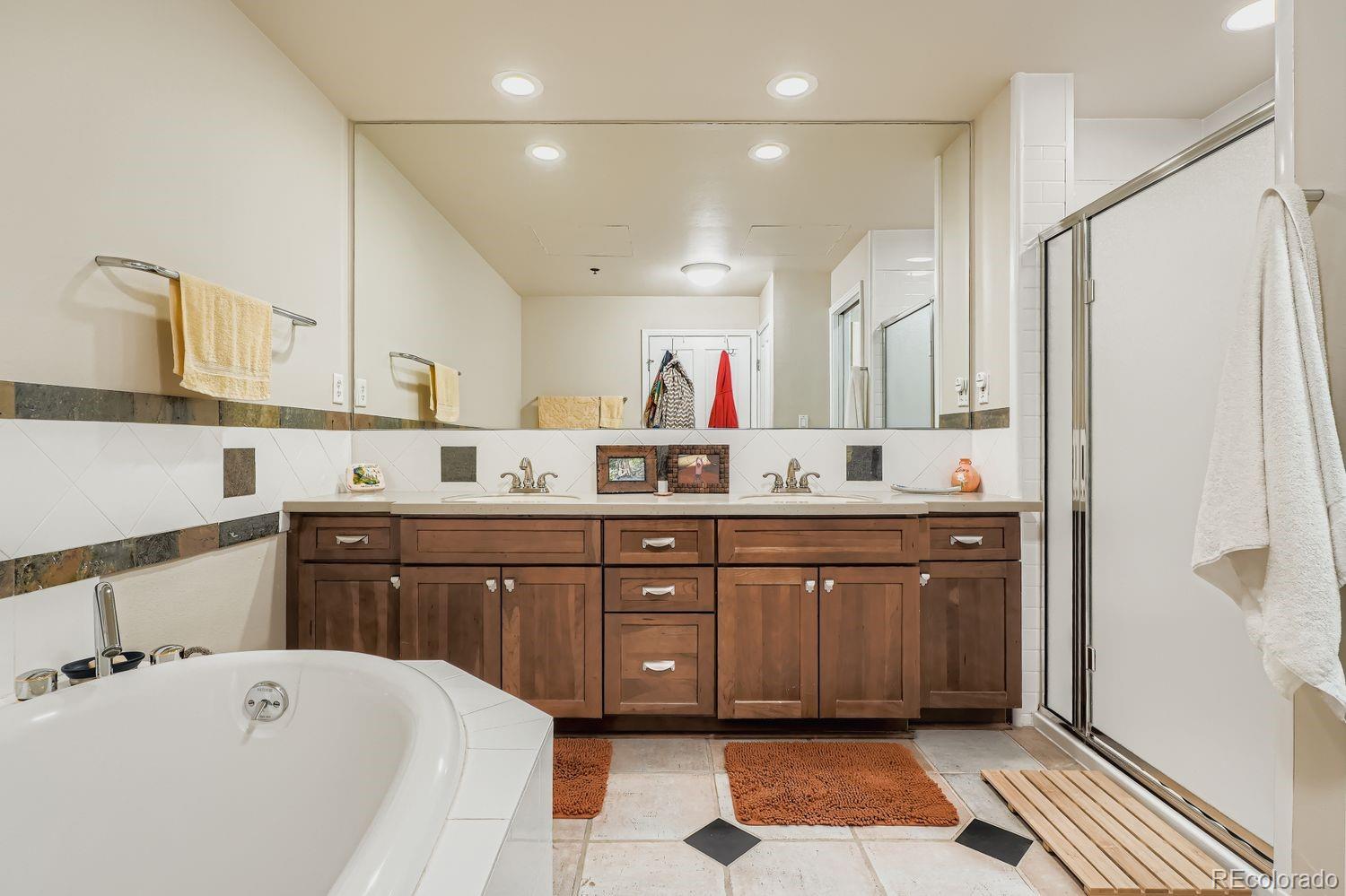 1499 Blake Street, Unit 4G Denver, CO 80202 - Photo 21 of 33 a spacious bathroom with a tub sink and mirror