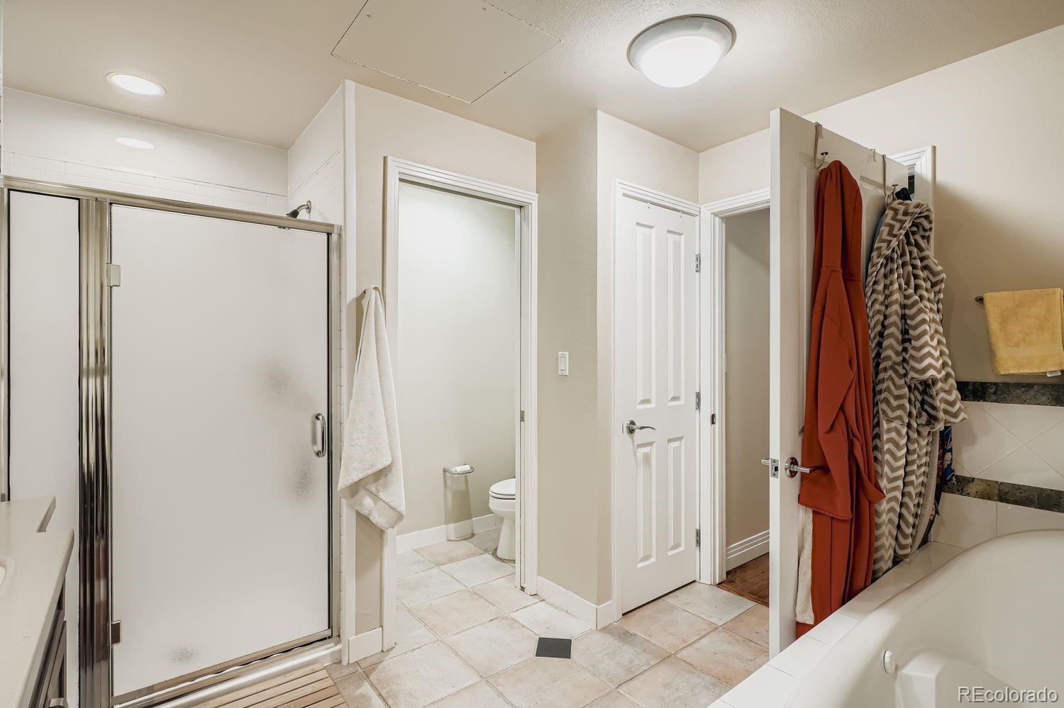 1499 Blake Street, Unit 4G Denver, CO 80202 - Photo 23 of 33 a bathroom with a granite countertop sink mirror and shower