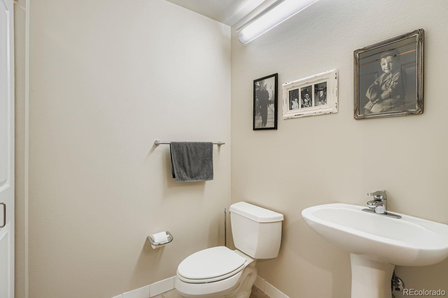 1499 Blake Street, Unit 4G Denver, CO 80202 - Photo 25 of 33 a bathroom with a toilet a sink and mirror