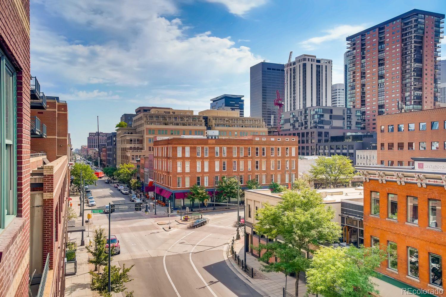 1499 Blake Street, Unit 4G Denver, CO 80202 - Photo 29 of 33 a building view with tall buildings and a yard in the background