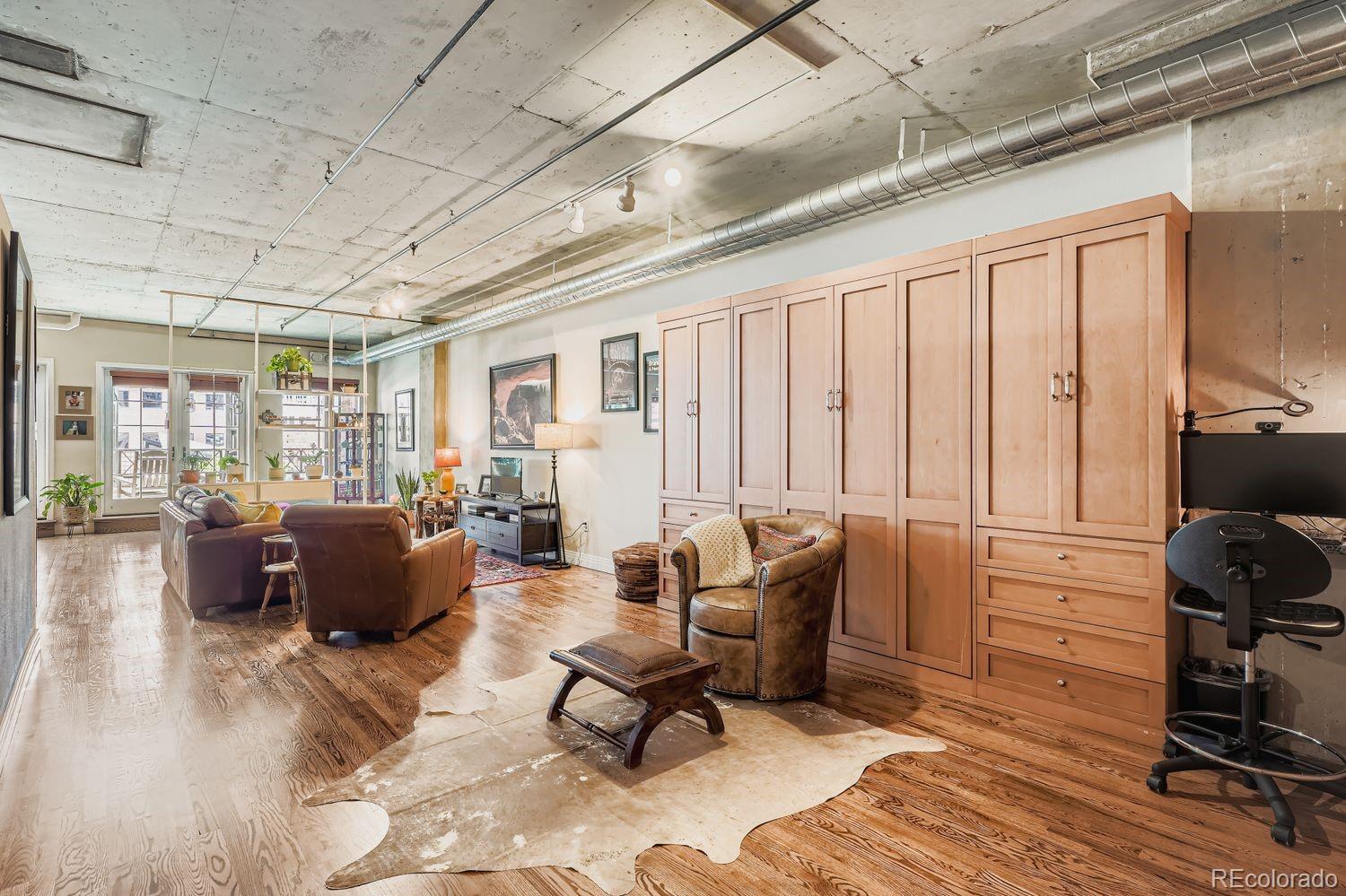 1499 Blake Street, Unit 4G Denver, CO 80202 - Photo 3 of 33 a living room with furniture or couch and a wooden floor