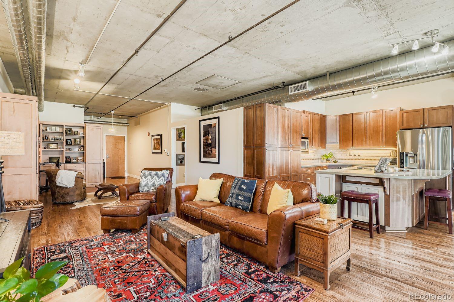 1499 Blake Street, Unit 4G Denver, CO 80202 - Photo 7 of 33 a living room with furniture and a large window
