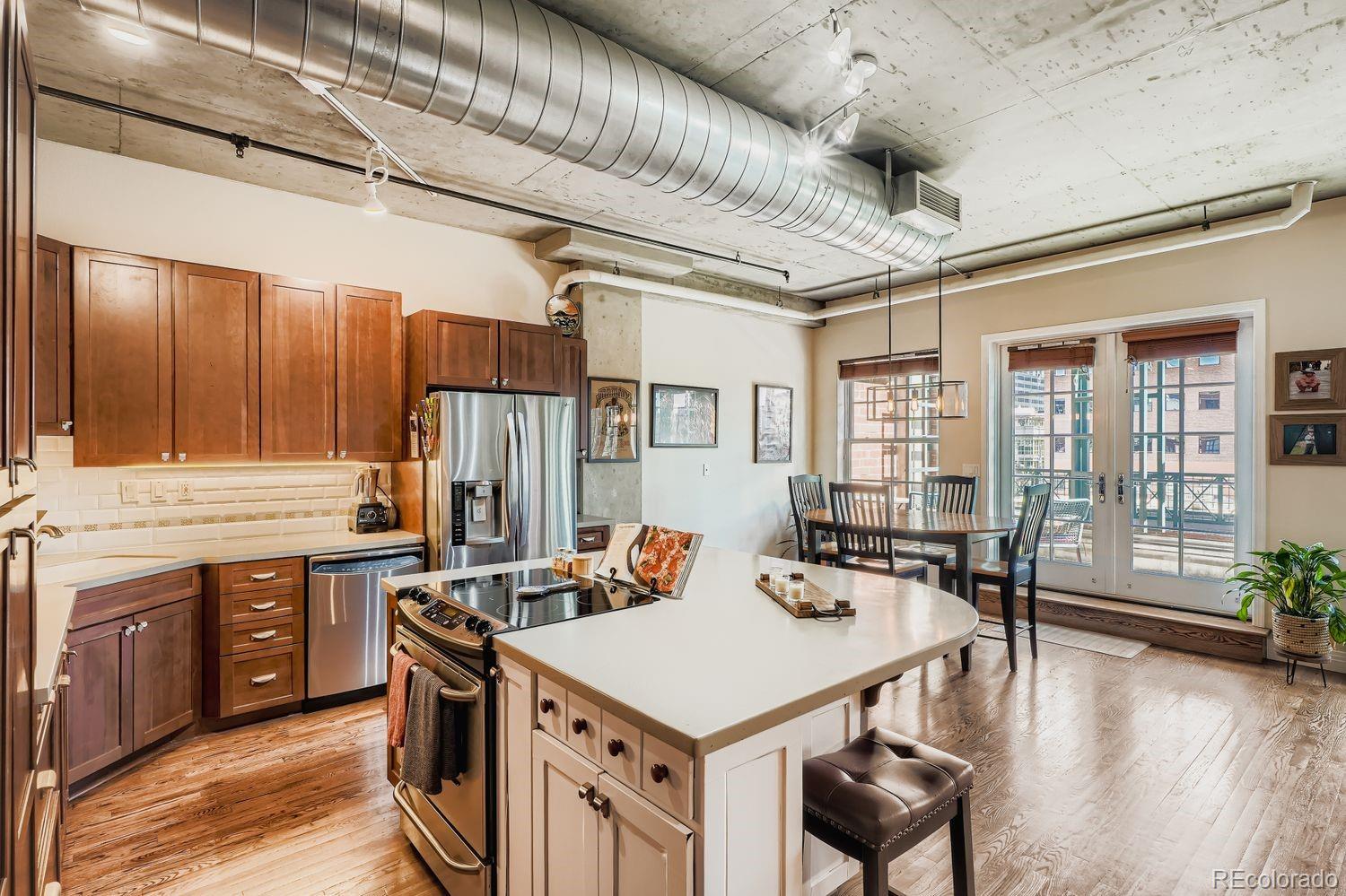 1499 Blake Street, Unit 4G Denver, CO 80202 - Photo 9 of 33 a kitchen that has a lot of cabinets in it