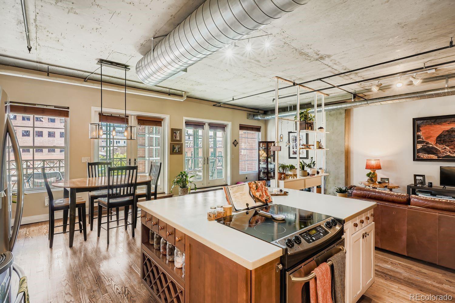 1499 Blake Street, Unit 4G Denver, CO 80202 - Photo 10 of 33 a kitchen with granite countertop a sink and a table chair