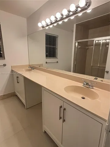 a bathroom with a glass door shower