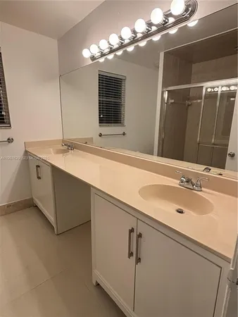 a bathroom with a glass door shower