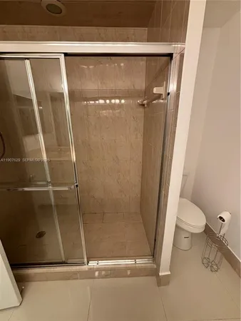 a bathroom with a shower and a sink