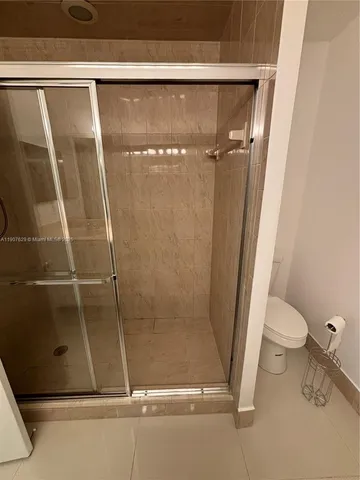 a bathroom with a shower and a sink