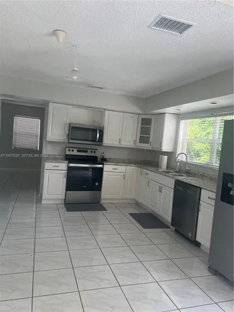 a view of an empty room with a chandelier